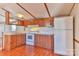 Kitchen with wood cabinets, white appliances, and wood flooring at 3586 Bridle Path Dr, Vale, NC 28168