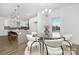 Open concept dining area with a glass table and white chairs next to the kitchen at 40242 Crooked Stick Dr # 1198, Lancaster, SC 29720