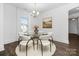 Bright dining room with glass table, white chairs, and hardwood floors at 40242 Crooked Stick Dr # 1198, Lancaster, SC 29720