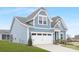 Side view of a charming two-story house with blue siding and a white garage door at 40242 Crooked Stick Dr # 1198, Lancaster, SC 29720