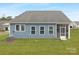 Rear view of house, blue siding, screened porch at 40242 Crooked Stick Dr # 1198, Lancaster, SC 29720