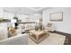 Living room with light beige sofas, coffee table, and view into the kitchen area at 40242 Crooked Stick Dr # 1198, Lancaster, SC 29720