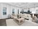 Spacious living room with light beige sofas, a wooden coffee table, and large windows at 40242 Crooked Stick Dr # 1198, Lancaster, SC 29720