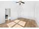 Bright bedroom featuring a ceiling fan, natural light, and wood-look floors at 613 Buffalo St, Shelby, NC 28150