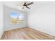 Bright bedroom featuring a ceiling fan, natural light, and wood-look floors at 613 Buffalo St, Shelby, NC 28150