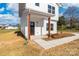 Welcoming front porch with wooden pillars and a modern black front door at 613 Buffalo St, Shelby, NC 28150