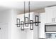 Unique pendant lighting fixture in the kitchen, complemented by white cabinetry at 613 Buffalo St, Shelby, NC 28150