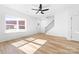 Bright living room with hardwood style floors, staircase, and natural light at 613 Buffalo St, Shelby, NC 28150