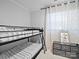 Cozy bedroom featuring a black metal bunk bed, complementing neutral decor and stylish geometric curtains at 724 Finley Rd, Rock Hill, SC 29730