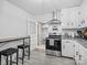 Galley kitchen with stainless steel appliances, white cabinetry, and dining table with barstool seating at 724 Finley Rd, Rock Hill, SC 29730