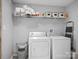 Functional laundry room with washer, dryer, and shelving for storage and organization at 724 Finley Rd, Rock Hill, SC 29730