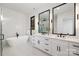 Modern bathroom with a freestanding tub and double vanity at 10614 Arlington Church Rd, Charlotte, NC 28227