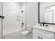 Clean bathroom with white tile, modern vanity, and bathtub at 10614 Arlington Church Rd, Charlotte, NC 28227