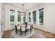 Bright dining room with glass table, light chairs, and large windows at 10614 Arlington Church Rd, Charlotte, NC 28227