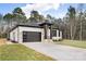 Contemporary home with a dark garage door and grassy yard at 10614 Arlington Church Rd, Charlotte, NC 28227