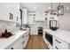 Modern kitchen with white cabinets, herringbone tile, and stainless steel appliances at 10614 Arlington Church Rd, Charlotte, NC 28227