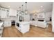 Open concept kitchen with white cabinets and a large island at 10614 Arlington Church Rd, Charlotte, NC 28227