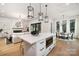 Open concept kitchen with white cabinets, island, and stainless steel appliances at 10614 Arlington Church Rd, Charlotte, NC 28227