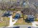Aerial view of three neighboring homes with long driveways, fenced yards and manicured landscaping in a suburban neighborhood at 1304 Pleasant Plains Rd, Matthews, NC 28105