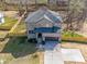 An aerial view shows the new construction home with an installed fence, a spacious yard, and a driveway at 1304 Pleasant Plains Rd, Matthews, NC 28105