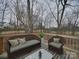 Cozy outdoor patio with stylish wicker furniture, inviting you to relax and enjoy the beautiful backyard scenery at 1304 Pleasant Plains Rd, Matthews, NC 28105