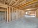 Unfinished basement showcasing open framing, concrete floor and cinder block foundation walls at 1304 Pleasant Plains Rd, Matthews, NC 28105