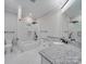 This bathroom features a gray speckled countertop, white cabinets and a tub-shower combo at 1304 Pleasant Plains Rd, Matthews, NC 28105