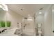 Bathroom featuring a tub-shower combo with glass doors, white tiles, and modern fixtures at 1304 Pleasant Plains Rd, Matthews, NC 28105