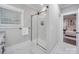 This bathroom has white marble-look tile, a glass shower and an adjoining bedroom at 1304 Pleasant Plains Rd, Matthews, NC 28105