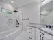 This bathroom features a gray speckled countertop, white cabinets and a tub-shower combo at 1304 Pleasant Plains Rd, Matthews, NC 28105