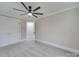 Bedroom features gray carpet, a ceiling fan, and closet at 1304 Pleasant Plains Rd, Matthews, NC 28105