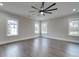 Large bedroom with wood floors, large windows, and a modern ceiling fan at 1304 Pleasant Plains Rd, Matthews, NC 28105