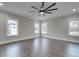 Bright bedroom with wood floors, a ceiling fan, and plenty of natural light at 1304 Pleasant Plains Rd, Matthews, NC 28105