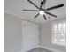 Bedroom with a modern ceiling fan, gray walls, and bright natural light from a window at 1304 Pleasant Plains Rd, Matthews, NC 28105
