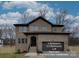 A new construction home features a full brick facade, a two-car garage, and a welcoming front entrance at 1304 Pleasant Plains Rd, Matthews, NC 28105