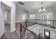 Open foyer with staircase, iron railing, wood floors, and natural light streaming through windows at 1304 Pleasant Plains Rd, Matthews, NC 28105