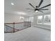 Upstairs landing featuring a ceiling fan, windows, and ornamental railing at 1304 Pleasant Plains Rd, Matthews, NC 28105