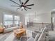 Comfortable living room with a ceiling fan, decorative rug, a grey sofa, and natural light at 1304 Pleasant Plains Rd, Matthews, NC 28105