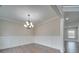 An empty living room features wainscoting, light gray walls, wood flooring, and natural light from a window at 1304 Pleasant Plains Rd, Matthews, NC 28105