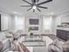 The living room has modern decor, including a faux fireplace, a glass coffee table, and light gray furniture at 1304 Pleasant Plains Rd, Matthews, NC 28105