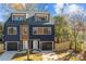 Modern two-unit building, navy and brown, with attached garages and fenced yards at 137 S Smallwood Pl, Charlotte, NC 28208