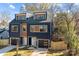 Modern two-unit building, navy and brown, with attached garages and fenced yards at 137 S Smallwood Pl, Charlotte, NC 28208