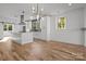 Modern kitchen featuring island, stainless steel appliances, and hardwood floors at 137 S Smallwood Pl, Charlotte, NC 28208