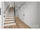 Light oak staircase with black railing in a modern home at 137 S Smallwood Pl, Charlotte, NC 28208