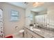 Guest bathroom with granite countertop and floral shower curtain at 137 Yellow Birch Loop, Mooresville, NC 28117