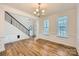 Bright dining room features hardwood floors and wainscoting at 137 Yellow Birch Loop, Mooresville, NC 28117