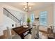 Virtually staged dining room with hardwood floors and large windows at 137 Yellow Birch Loop, Mooresville, NC 28117