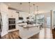 Modern kitchen with granite island, stainless steel appliances, and white cabinets at 137 Yellow Birch Loop, Mooresville, NC 28117