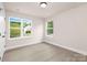 Simple bedroom with two windows and light grey wood flooring at 1823 Bristol Rd, Statesville, NC 28677