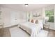 Spacious bedroom with a king-size bed, neutral decor, and double doors at 1823 Bristol Rd, Statesville, NC 28677